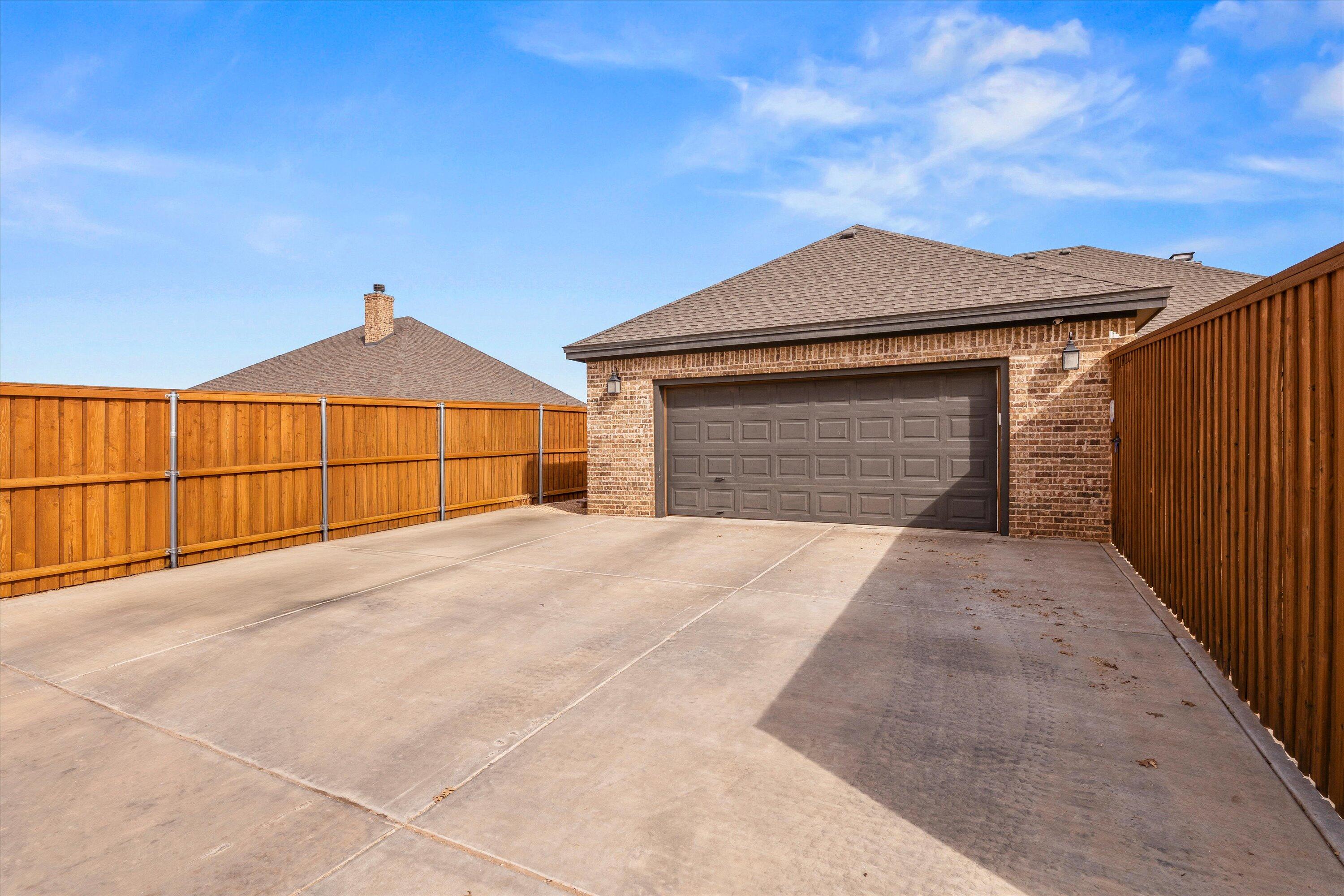 7033 101st Street Lubbock, TX 79424 - Photo 37 of 38 a front view of a house with a garage