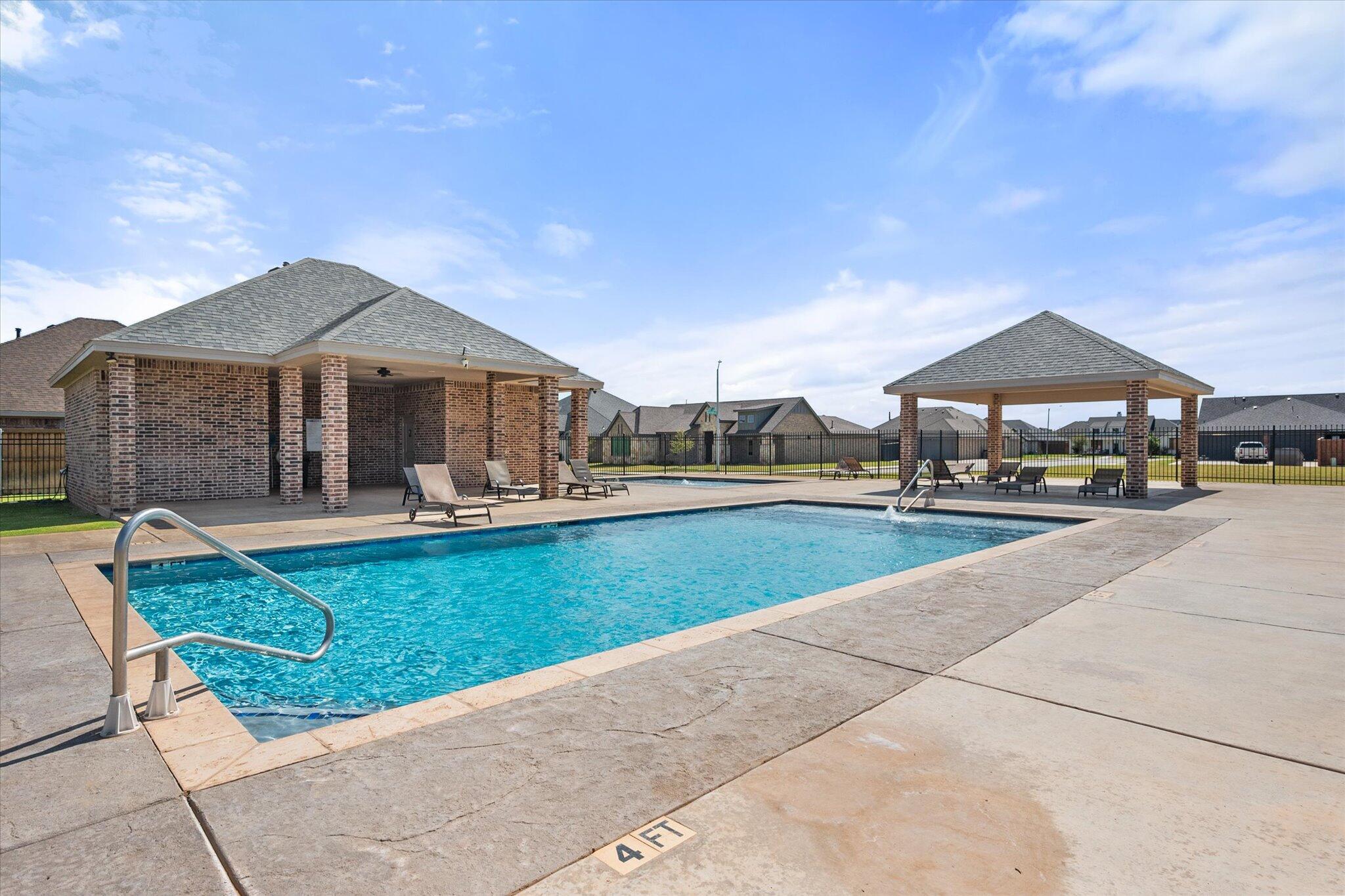 7033 101st Street Lubbock, TX 79424 - Photo 38 of 38 a swimming pool view with a seating space and a garden view