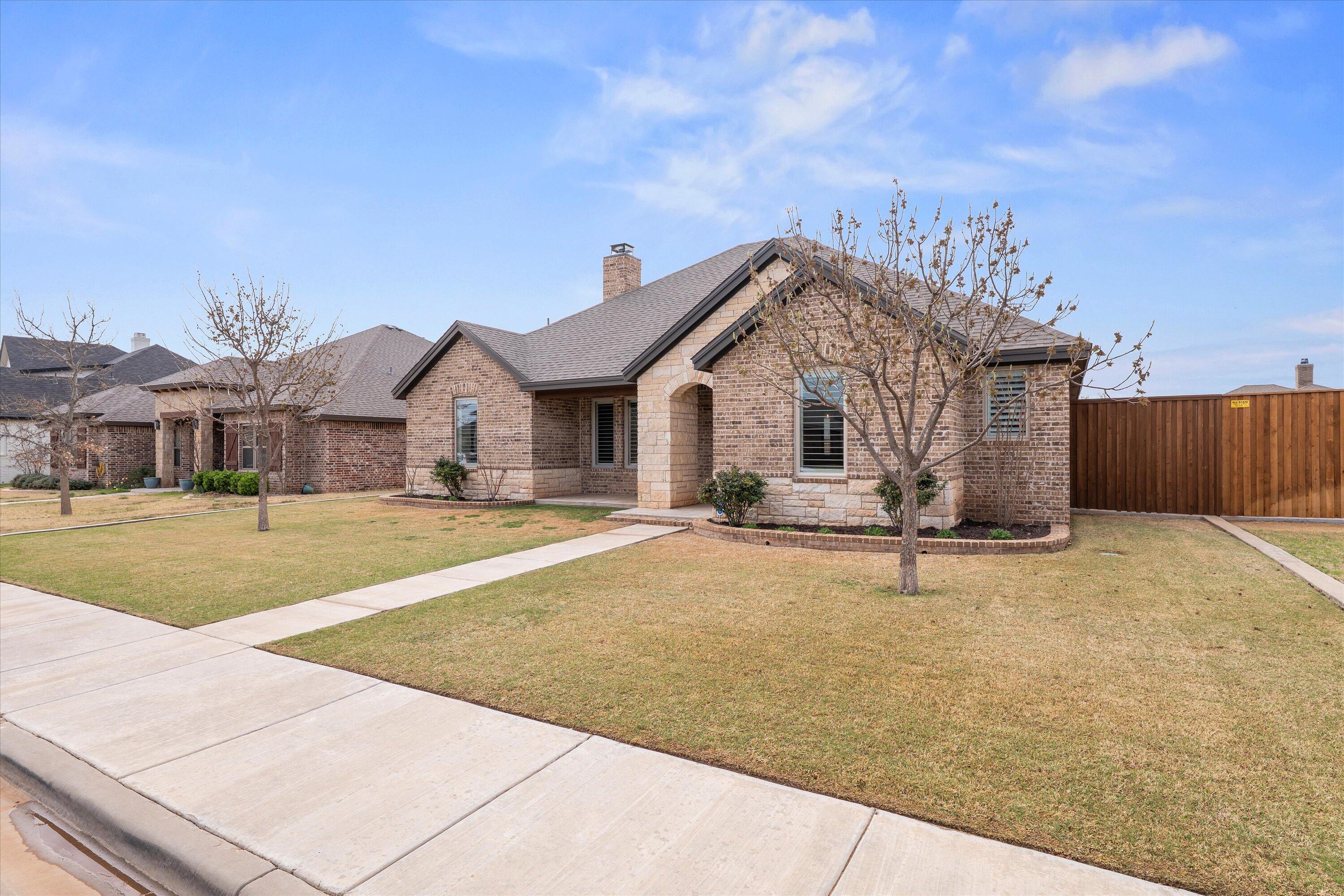 7033 101st Street Lubbock, TX 79424 - Photo 5 of 38 a front view of a house with a yard
