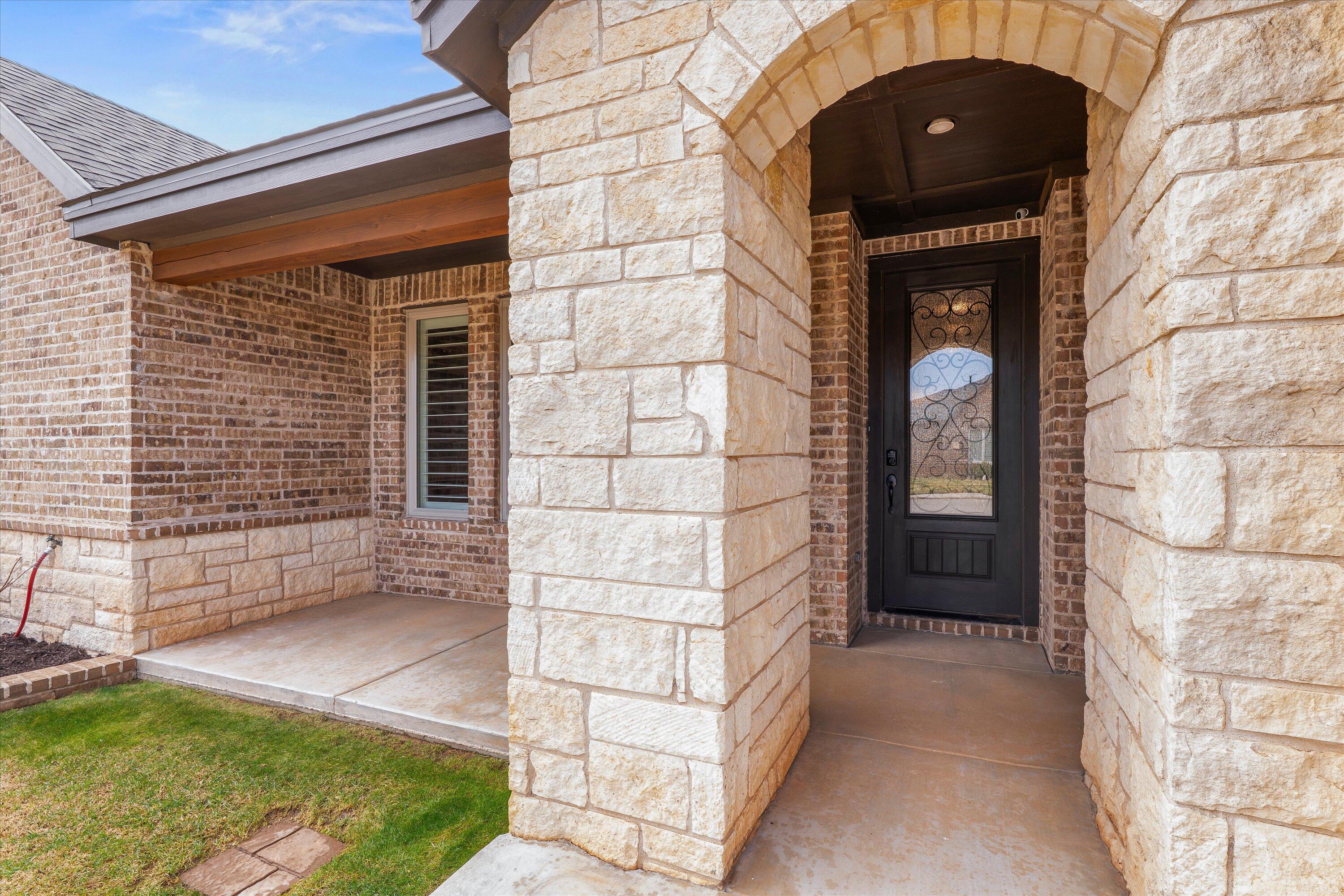 7033 101st Street Lubbock, TX 79424 - Photo 6 of 38 a brick building with a door and a window
