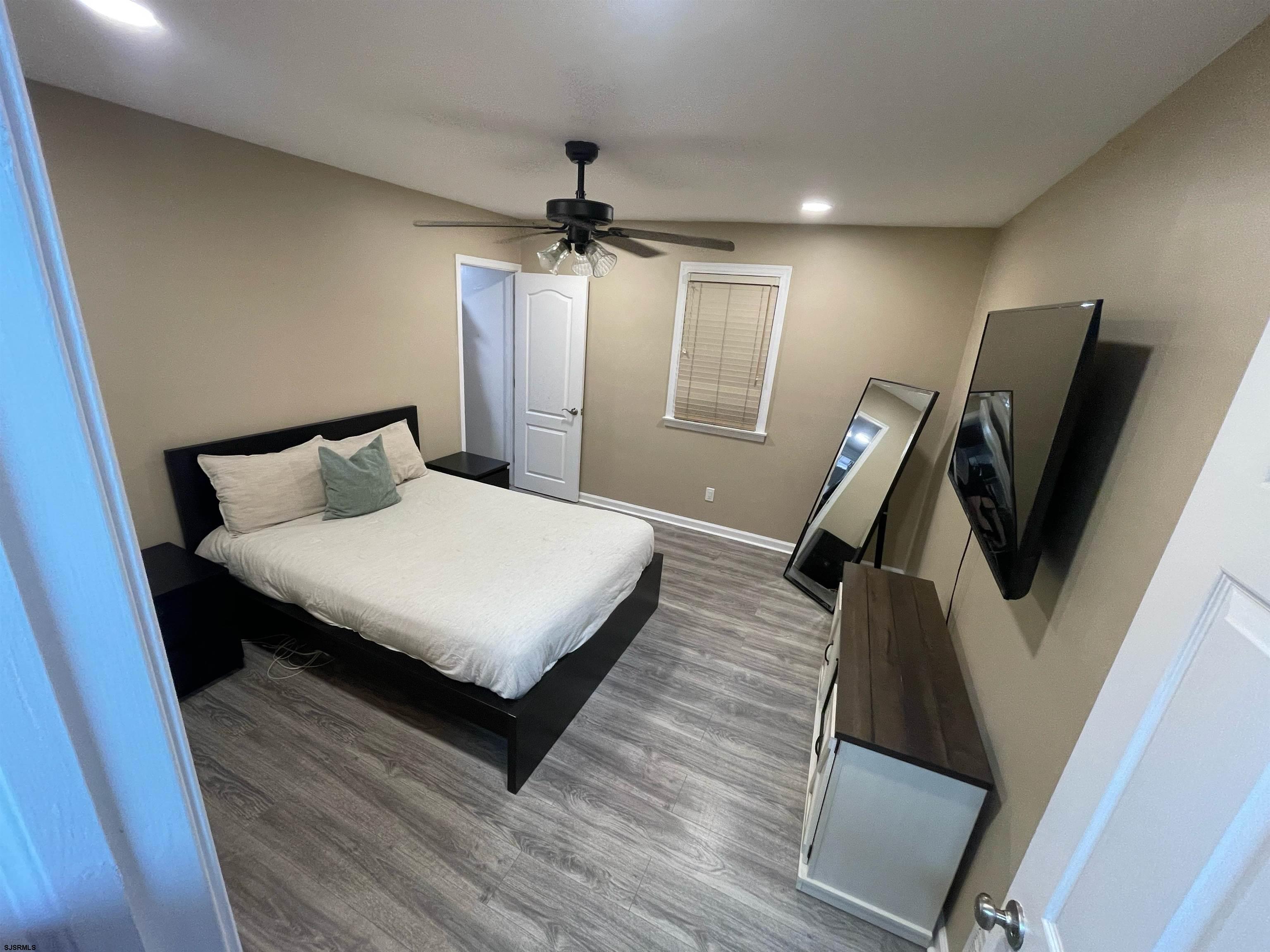 241 Warren Avenue Bellmawr, NJ 08031 - Photo 15 of 26 a bedroom with a bed a flat screen tv and a dresser