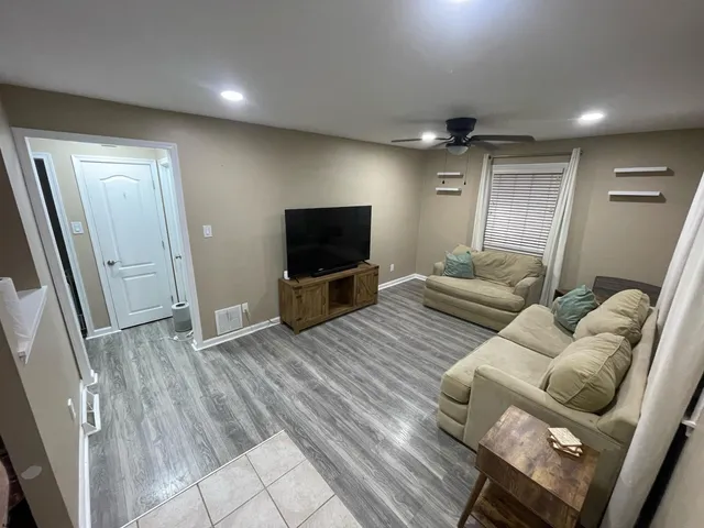 a kitchen with a refrigerator and white cabinets