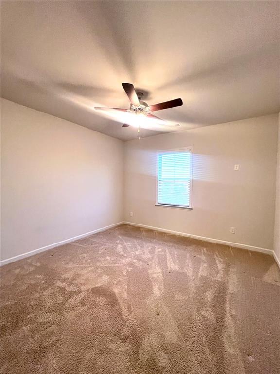 2464 Pinnae Place Buford, GA 30519 - Photo 8 of 18 an empty room with windows and fan