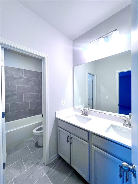 2464 Pinnae Place Buford, GA 30519 - Photo 10 of 18 a bathroom with a sink a toilet and shower