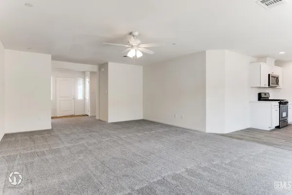 an empty room with closet and windows