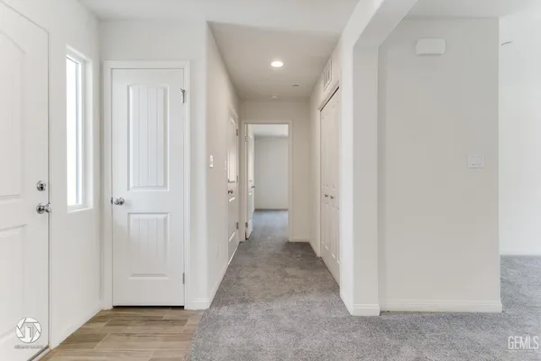 a kitchen with stainless steel appliances a stove a microwave oven cabinets and wooden floor