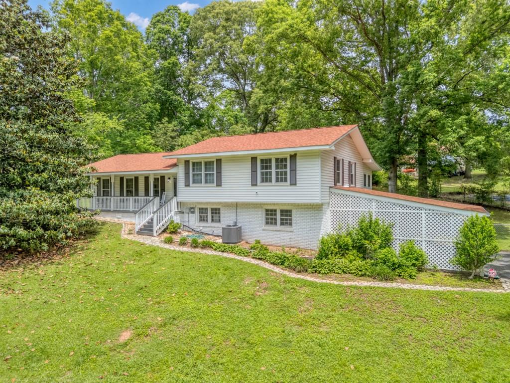 83 Summit Ridge Circle Southeast Cartersville, GA 30120 - Photo 1 of 32 a front view of a house with a yard