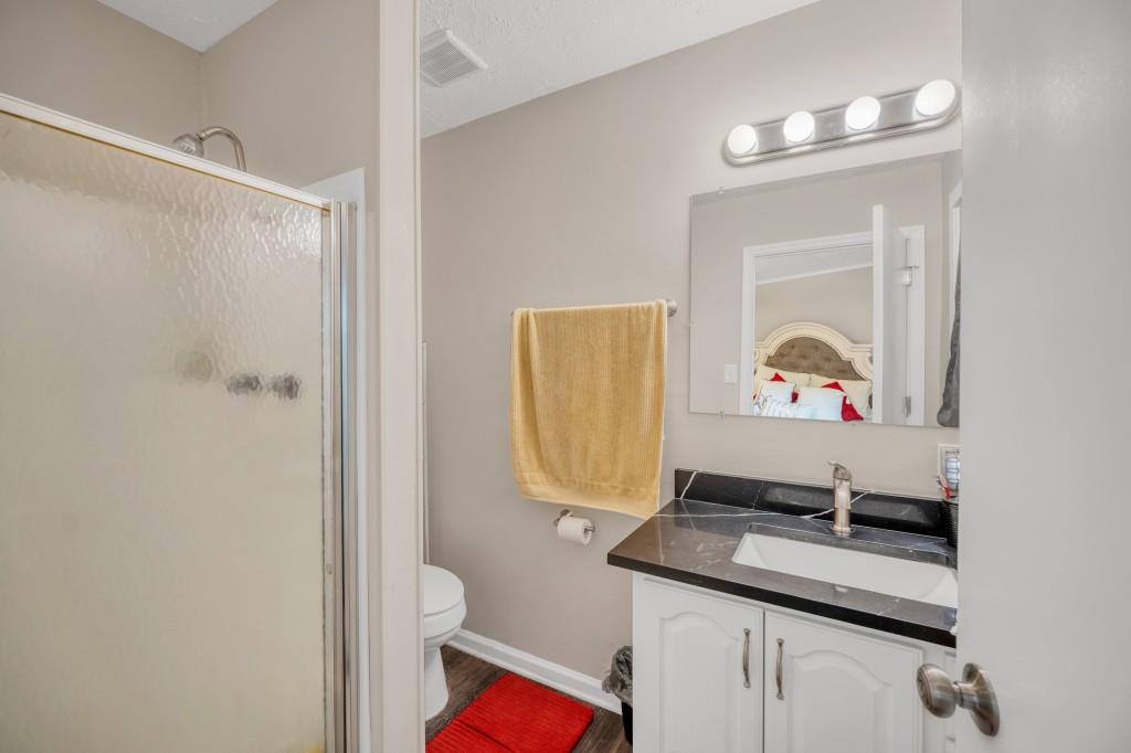83 Summit Ridge Circle Southeast Cartersville, GA 30120 - Photo 13 of 32 a bathroom with a sink a mirror and a toilet