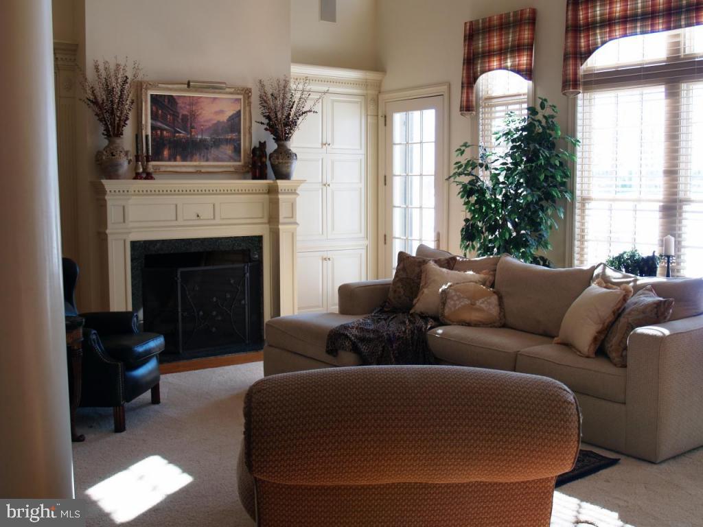 38 Oakhill Drive Lititz, PA 17543 - Photo 8 of 37 a living room with furniture a fireplace and a window