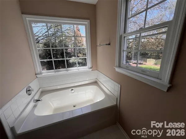 a bathroom with a bathtub and a window