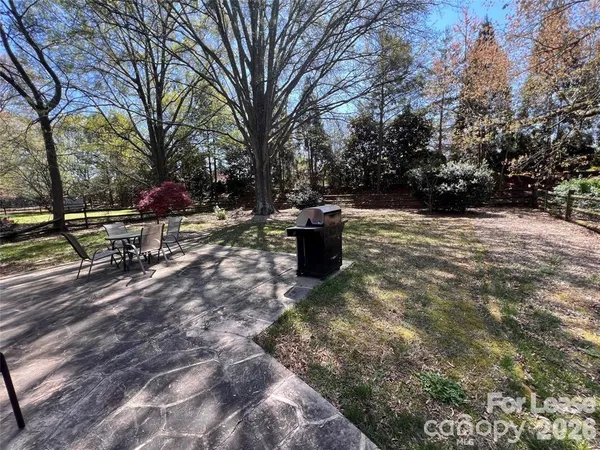 a view of a backyard with wooden fence