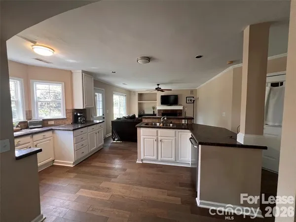 a large kitchen with kitchen island granite countertop a sink counter space and stainless steel appliances