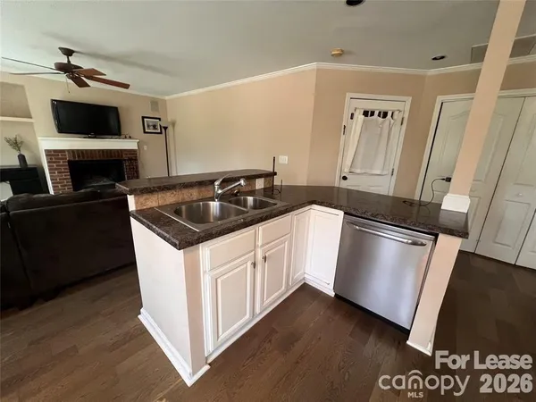 a kitchen with granite countertop a sink and a stove top oven