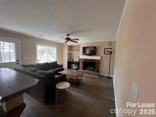 a living room with furniture a fireplace and a potted plant