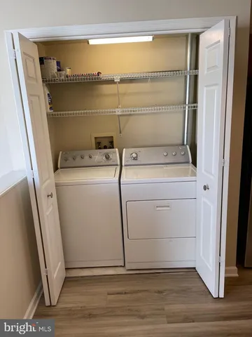 a view of washer and dryer with wooden floor