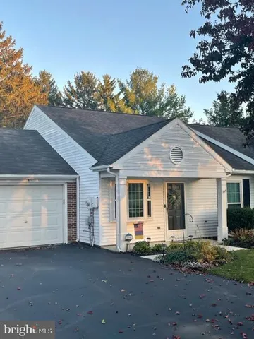 a view of a house with a yard and garage