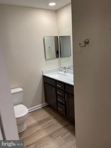 a bathroom with a toilet a sink and mirror