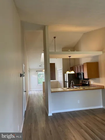 a view of a living room and kitchen with furniture