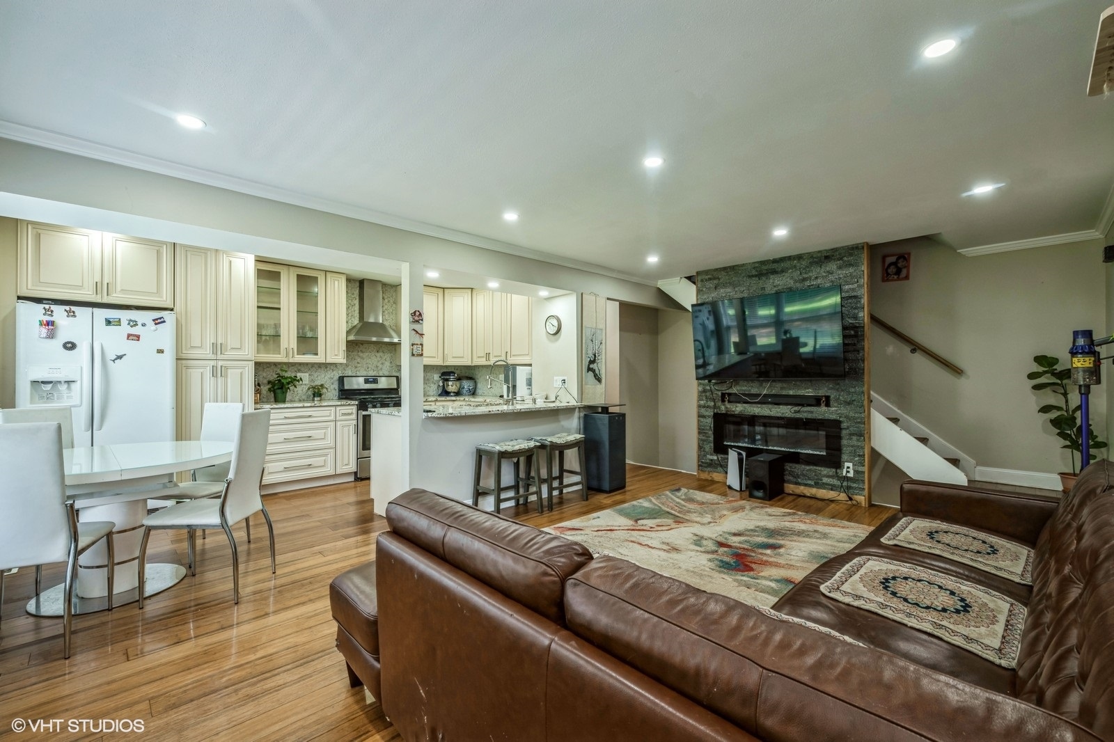 1138 Inverrary Lane Deerfield, IL 60015 - Photo 4 of 12 a living room with couches and kitchen view with wooden floor