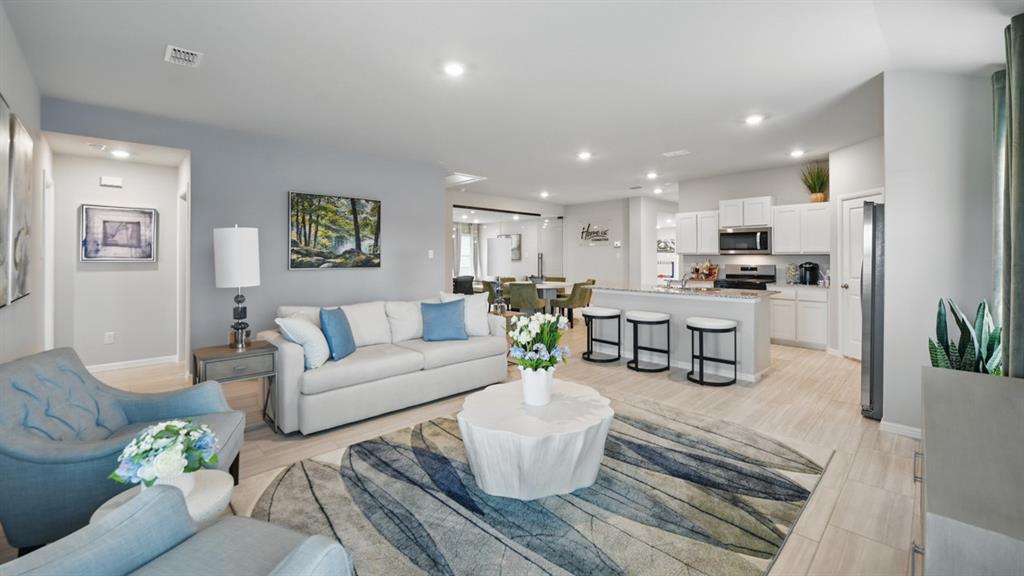 5545 Legends Way Krum, TX 76249 - Photo 10 of 36 a living room with furniture and kitchen view