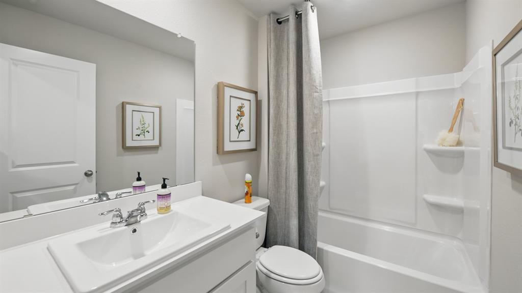 5545 Legends Way Krum, TX 76249 - Photo 23 of 36 a bathroom with a sink toilet and shower
