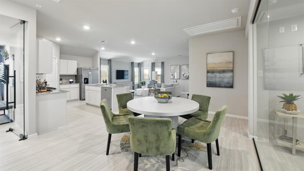 5545 Legends Way Krum, TX 76249 - Photo 5 of 36 a view of a dining room with furniture and wooden floor