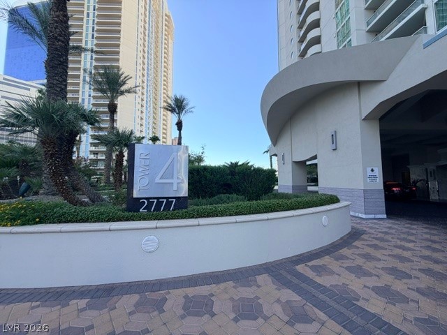 2777 Paradise Road, Unit 807 Las Vegas, NV 89109 - Photo 2 of 61 A grand entrance welcomes residents and guests to Tower 4, featuring lush landscaping and a modern sign.