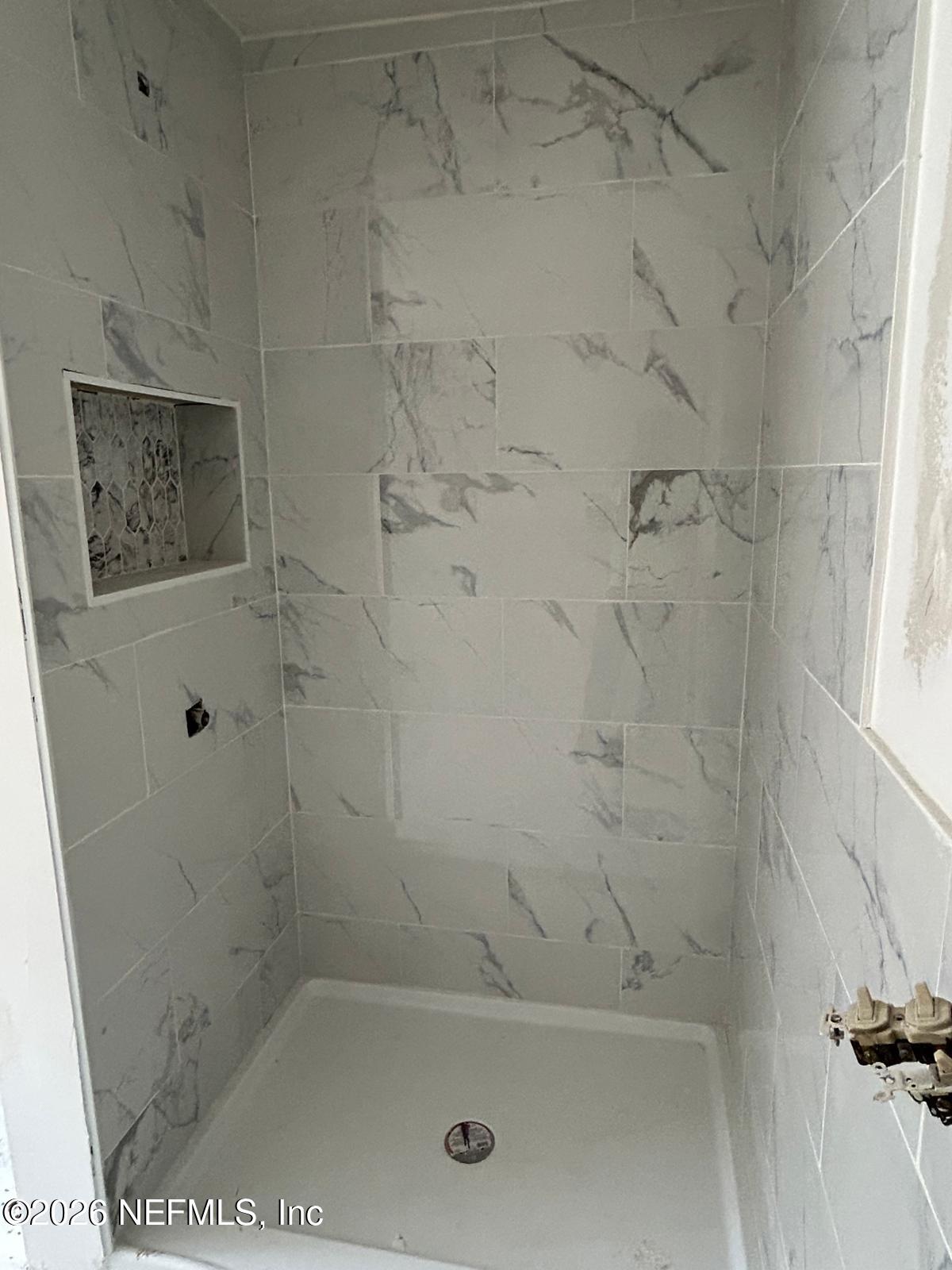 9959 Lem Turner Road Jacksonville, FL 32208 - Photo 16 of 22 a close up of a bathtub