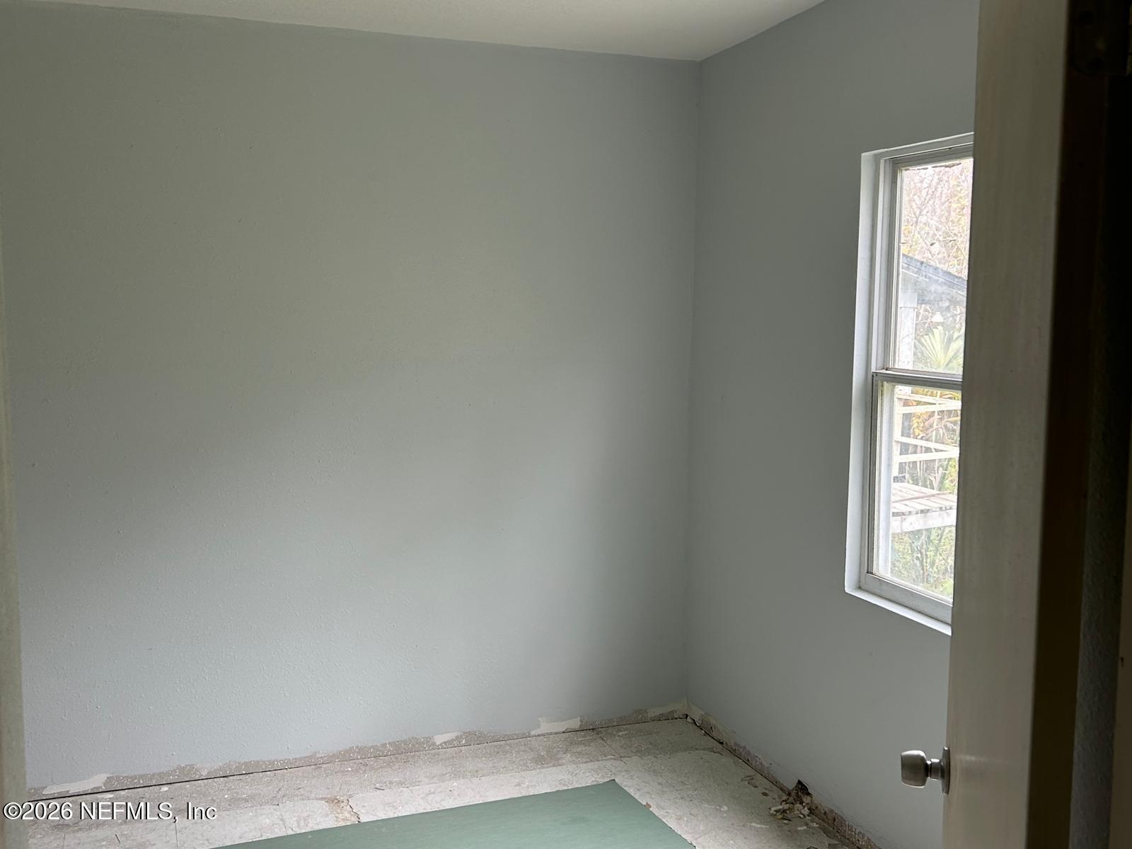 9959 Lem Turner Road Jacksonville, FL 32208 - Photo 5 of 22 an empty room with windows