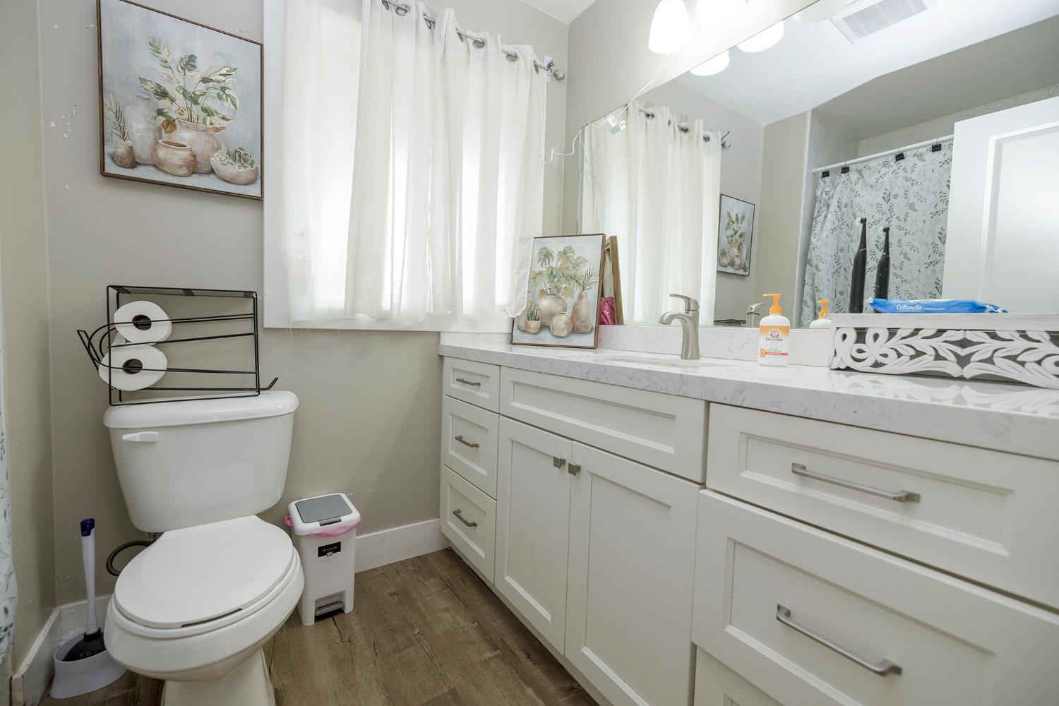8712 Yosemite Boulevard Modesto, CA 95357 - Photo 15 of 24 a bathroom with a toilet sink and mirror