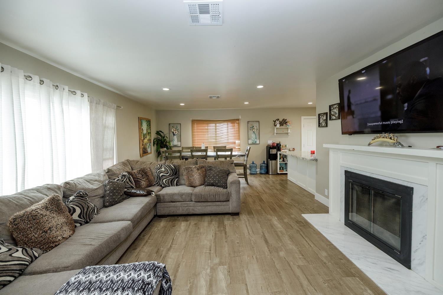 8712 Yosemite Boulevard Modesto, CA 95357 - Photo 7 of 24 a living room with furniture a fireplace and a flat screen tv