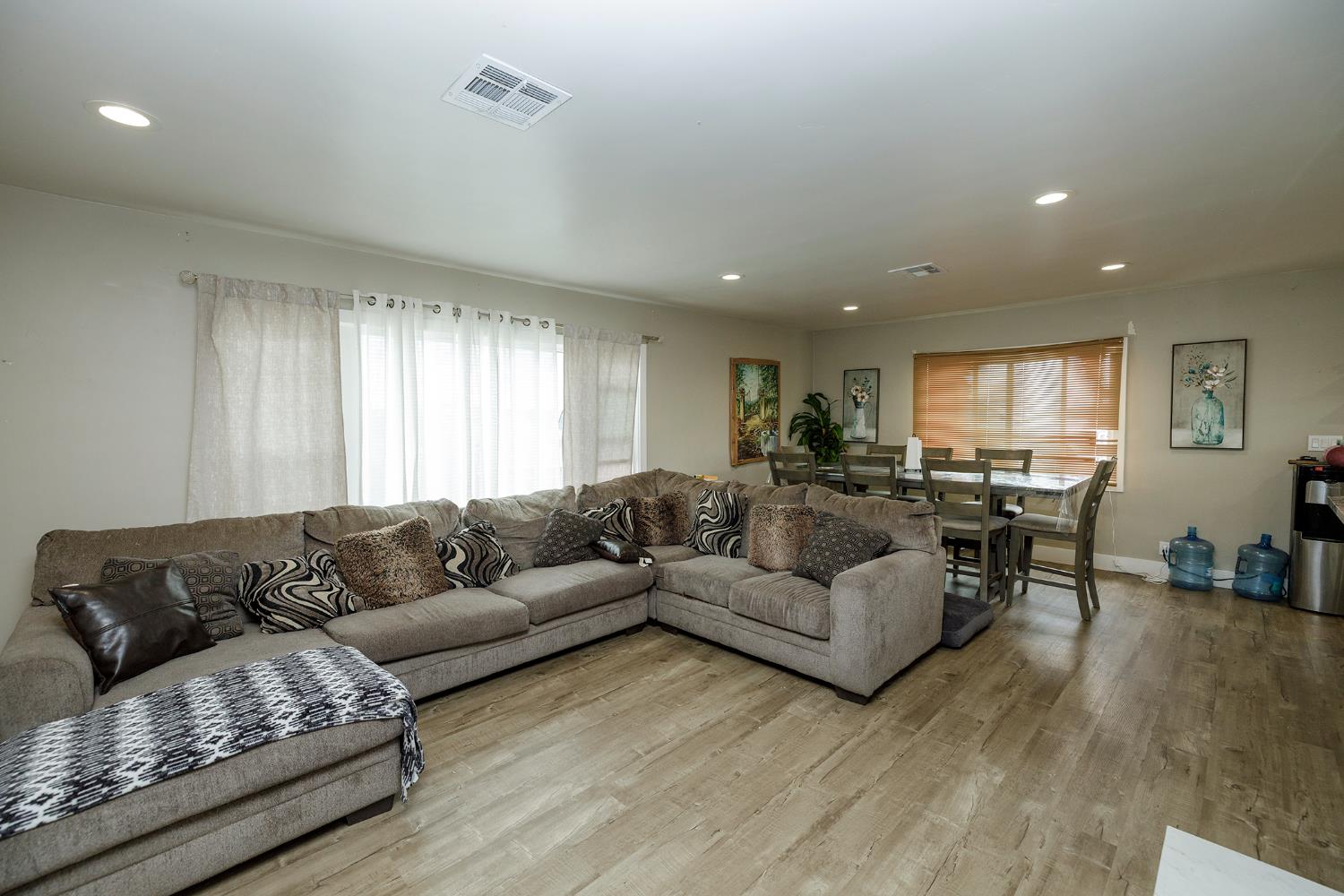 8712 Yosemite Boulevard Modesto, CA 95357 - Photo 8 of 24 a living room with couches and kitchen view with wooden floor