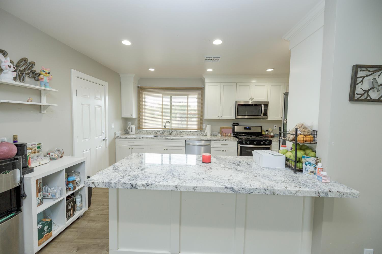 8712 Yosemite Boulevard Modesto, CA 95357 - Photo 9 of 24 a kitchen with stainless steel appliances granite countertop a sink stove and refrigerator