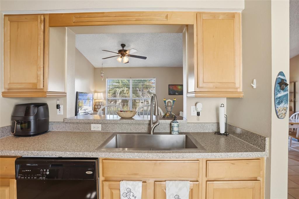 10735 Lake Ralph Drive Clermont, FL 34711 - Photo 12 of 37 a kitchen with granite countertop a sink a stove and cabinets