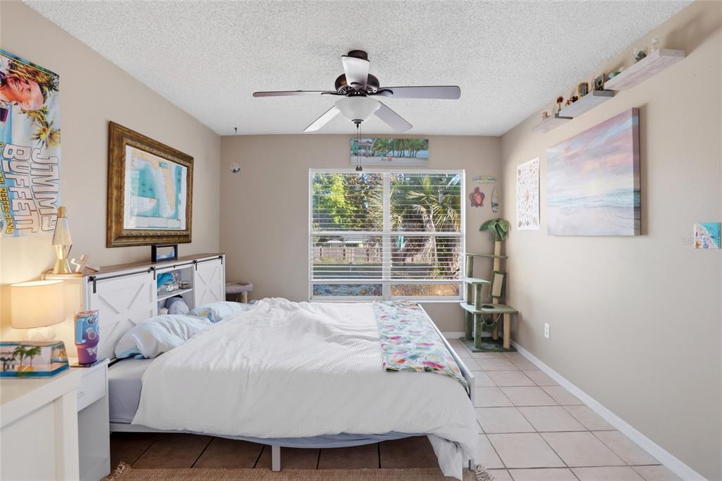 10735 Lake Ralph Drive Clermont, FL 34711 - Photo 16 of 37 a bedroom with a bed and a large window
