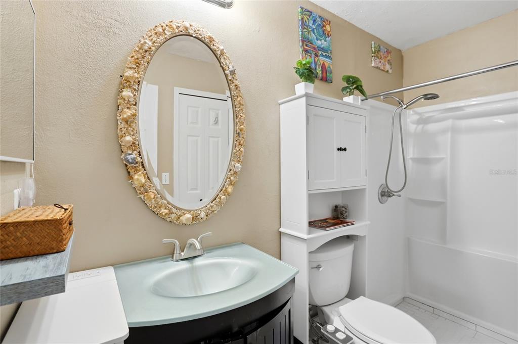 10735 Lake Ralph Drive Clermont, FL 34711 - Photo 17 of 37 a bathroom with a sink a toilet and a mirror