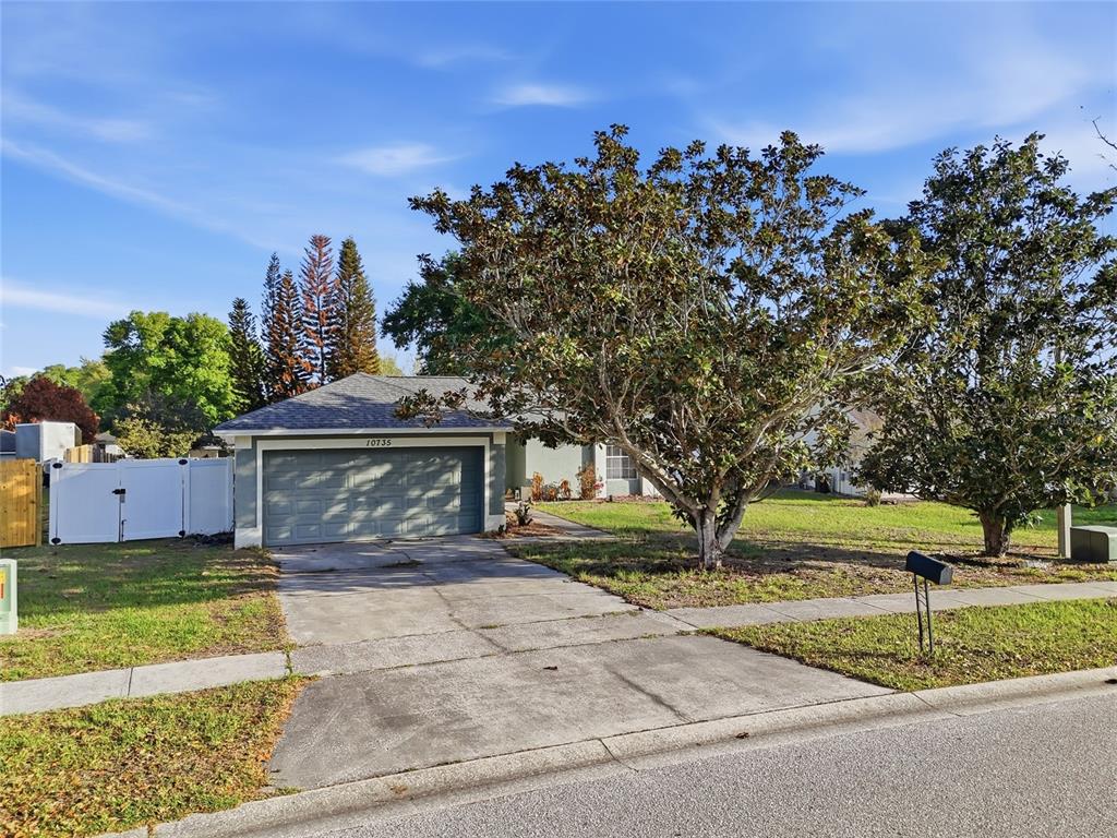 10735 Lake Ralph Drive Clermont, FL 34711 - Photo 2 of 37 a front view of a house with garden