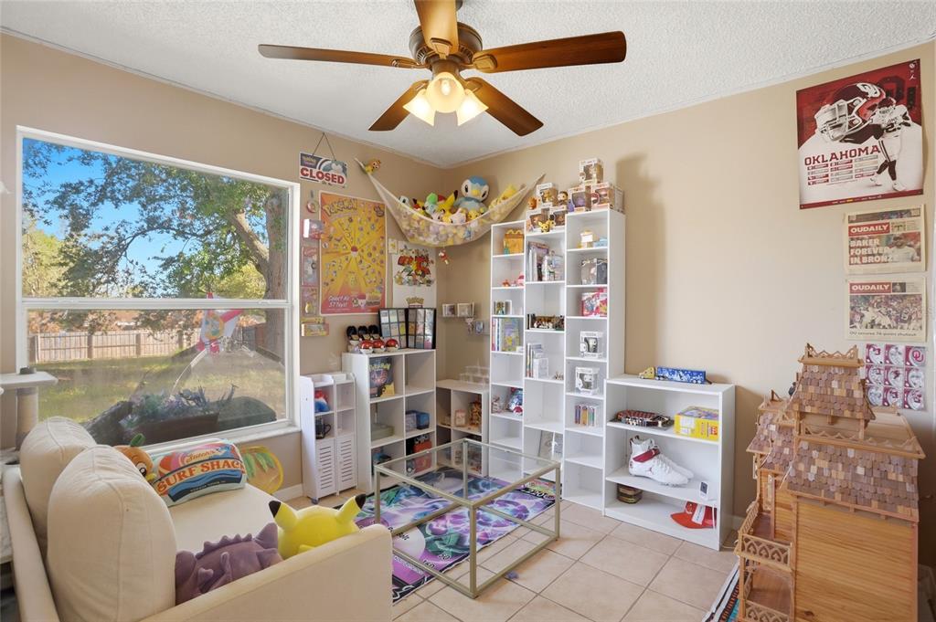 10735 Lake Ralph Drive Clermont, FL 34711 - Photo 21 of 37 a living room with furniture and a large window