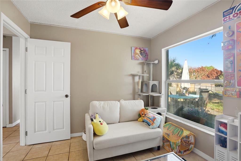 10735 Lake Ralph Drive Clermont, FL 34711 - Photo 22 of 37 a living room with furniture and a floor to ceiling window