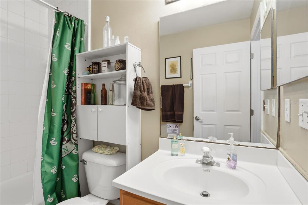 10735 Lake Ralph Drive Clermont, FL 34711 - Photo 23 of 37 a bathroom with a sink a toilet and shower