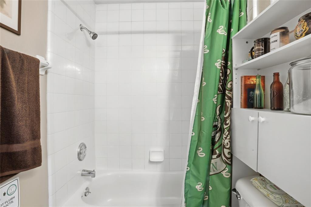 10735 Lake Ralph Drive Clermont, FL 34711 - Photo 24 of 37 a bathroom with a shower and a tub