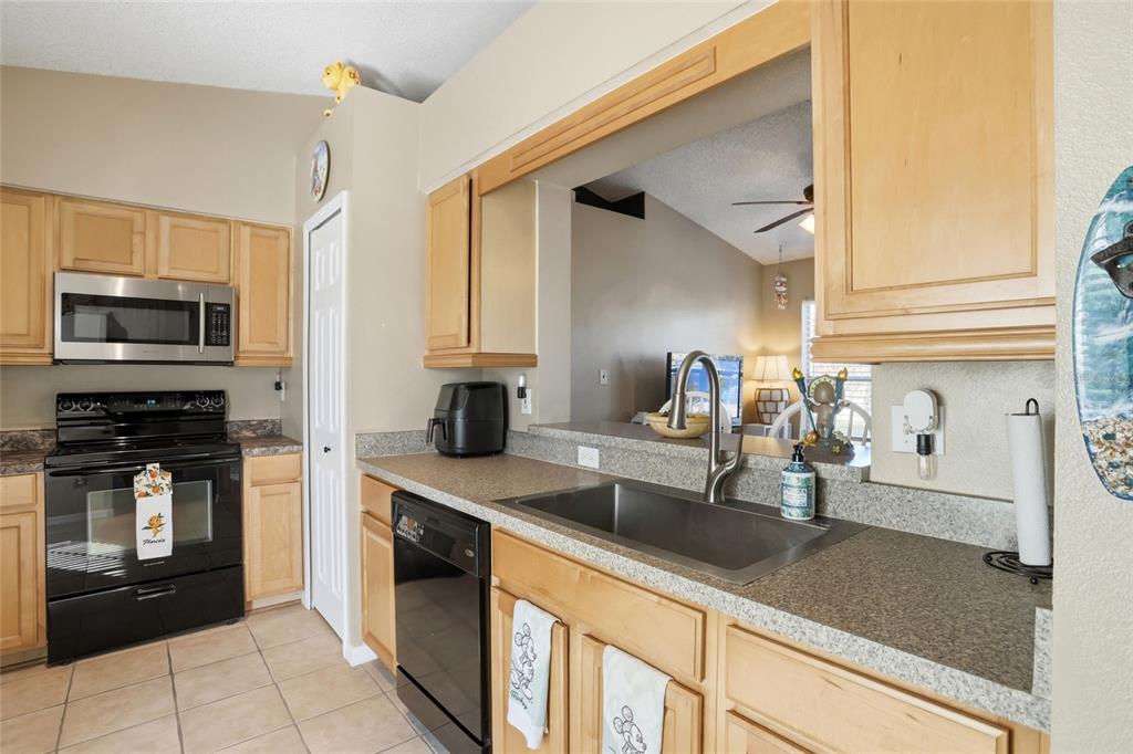 10735 Lake Ralph Drive Clermont, FL 34711 - Photo 7 of 37 a kitchen with stainless steel appliances granite countertop a sink and a stove