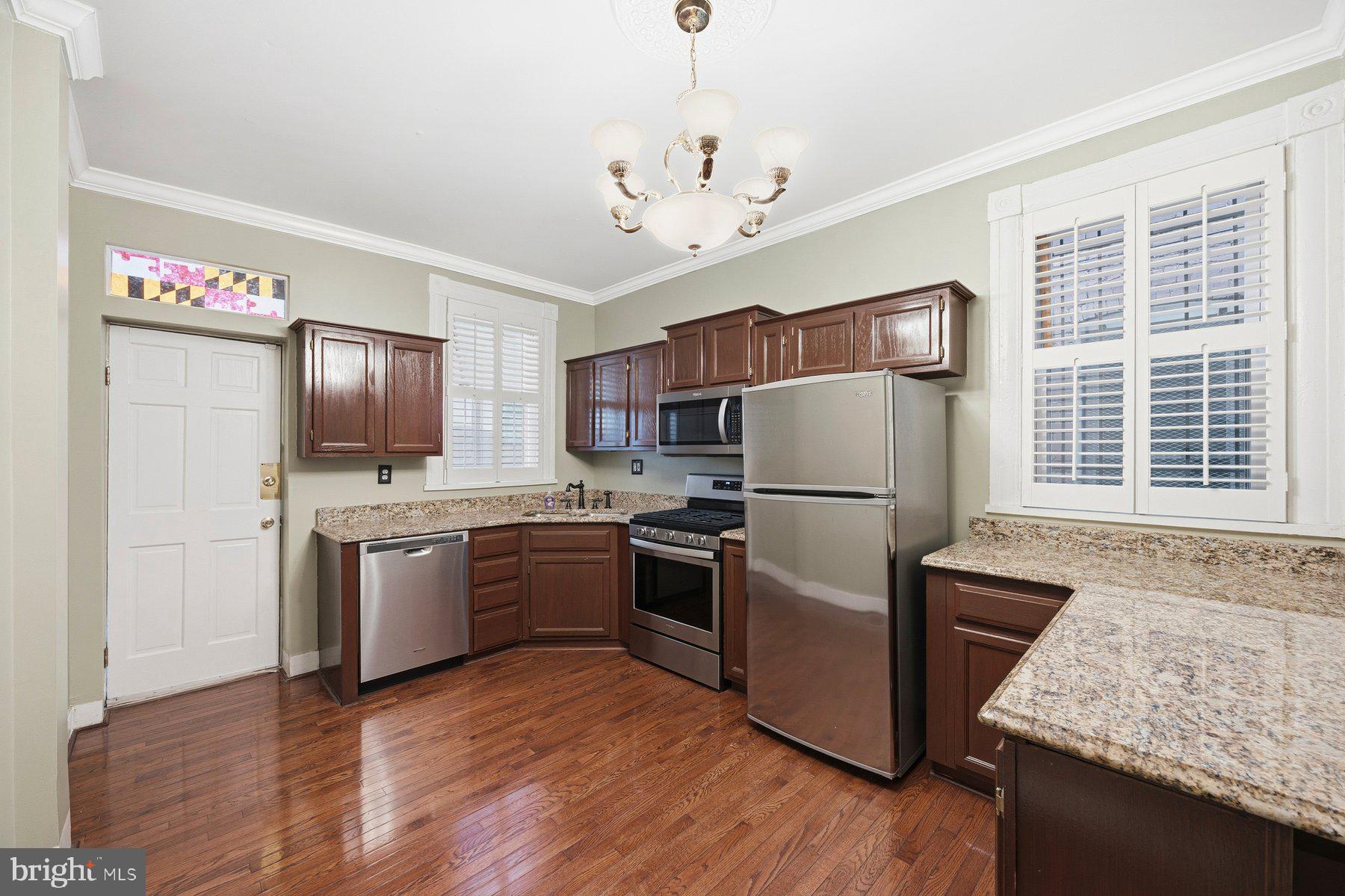 208 East Eager Street Baltimore, MD 21202 - Photo 11 of 31 a kitchen with stainless steel appliances granite countertop a refrigerator stove microwave and sink