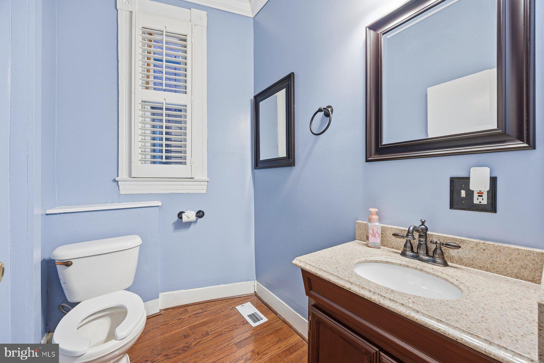 208 East Eager Street Baltimore, MD 21202 - Photo 12 of 31 a bathroom with a toilet a sink and mirror