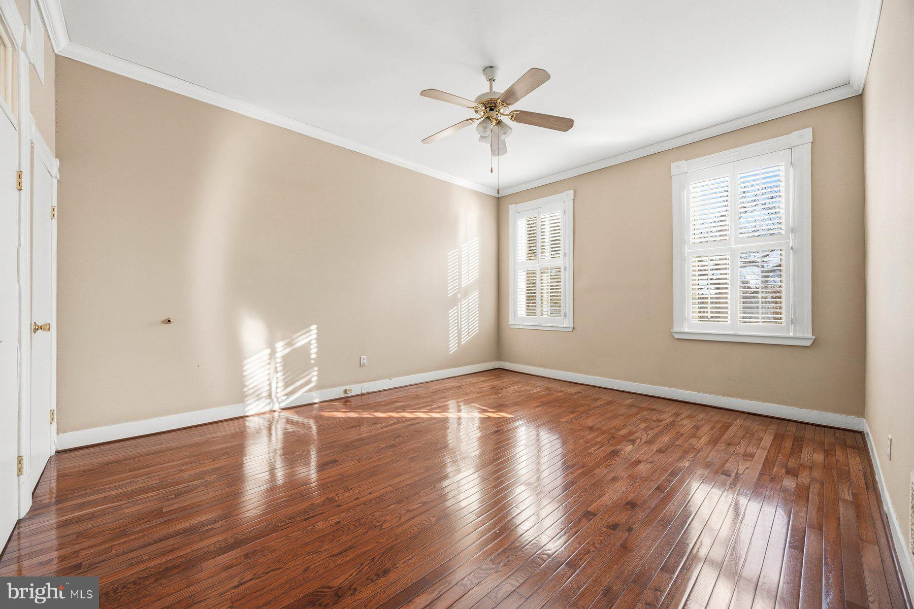 208 East Eager Street Baltimore, MD 21202 - Photo 13 of 31 a view of an empty room with wooden floor and a window