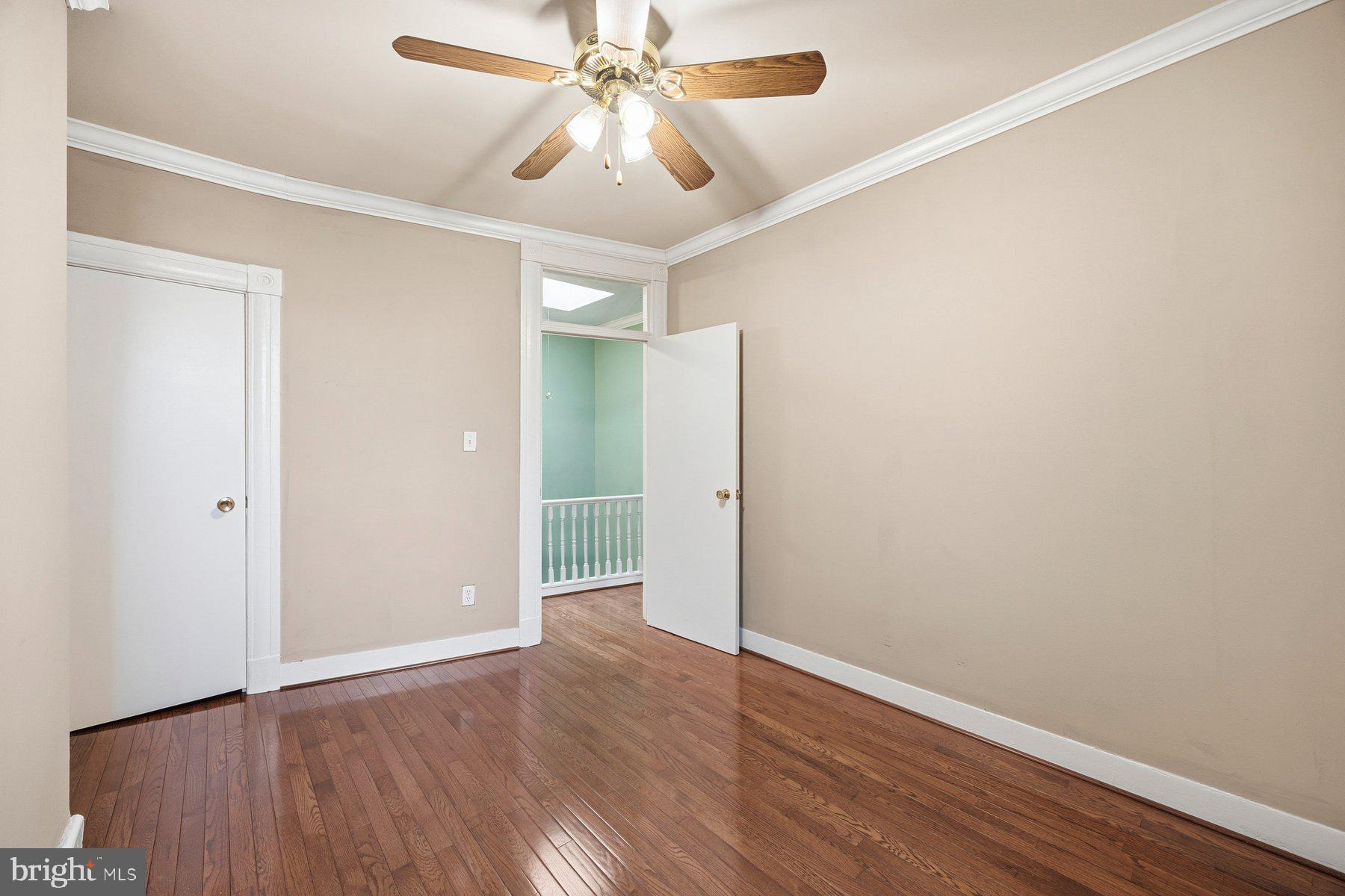 208 East Eager Street Baltimore, MD 21202 - Photo 16 of 31 an empty room with wooden floor and windows