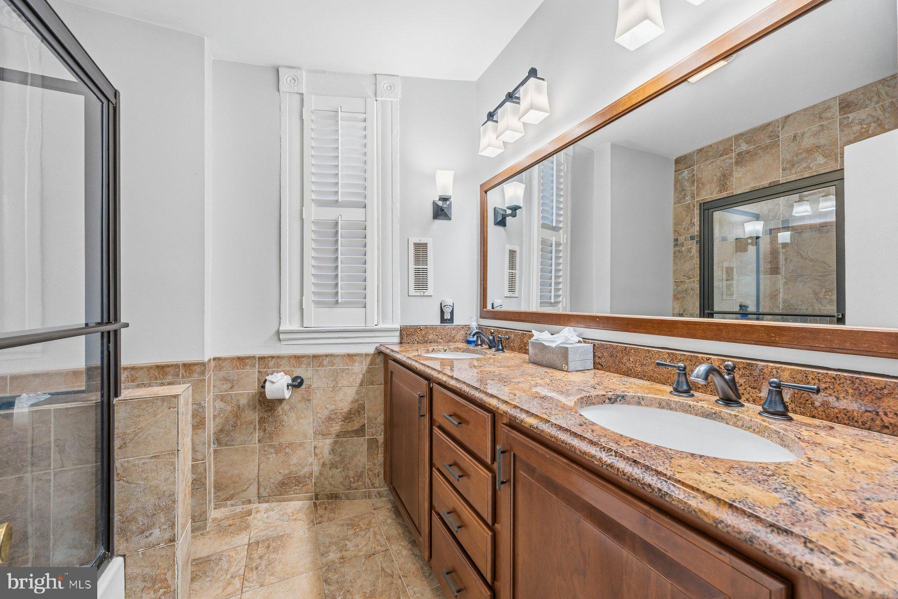 208 East Eager Street Baltimore, MD 21202 - Photo 17 of 31 a bathroom with a granite countertop sink and a mirror