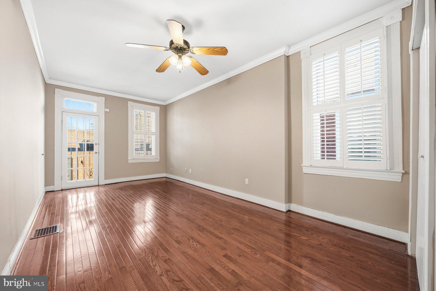 208 East Eager Street Baltimore, MD 21202 - Photo 19 of 31 a view of an empty room with wooden floor and a window