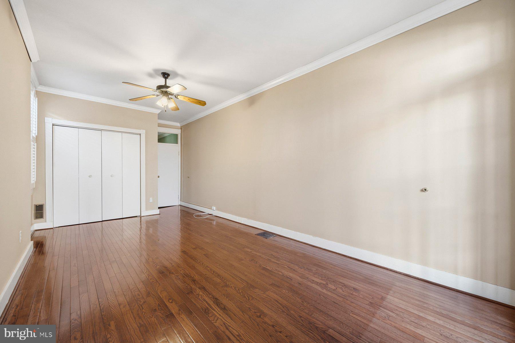208 East Eager Street Baltimore, MD 21202 - Photo 21 of 31 a view of an empty room with wooden floor