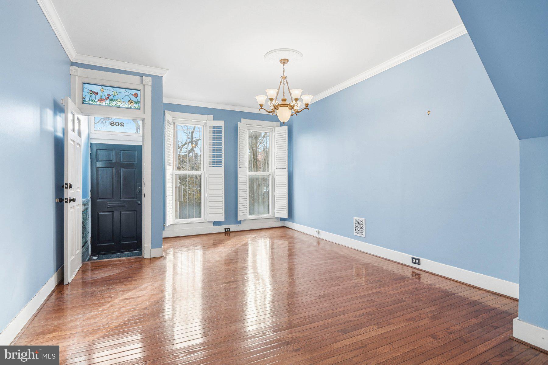 208 East Eager Street Baltimore, MD 21202 - Photo 3 of 31 a view of an empty room with wooden floor and a window